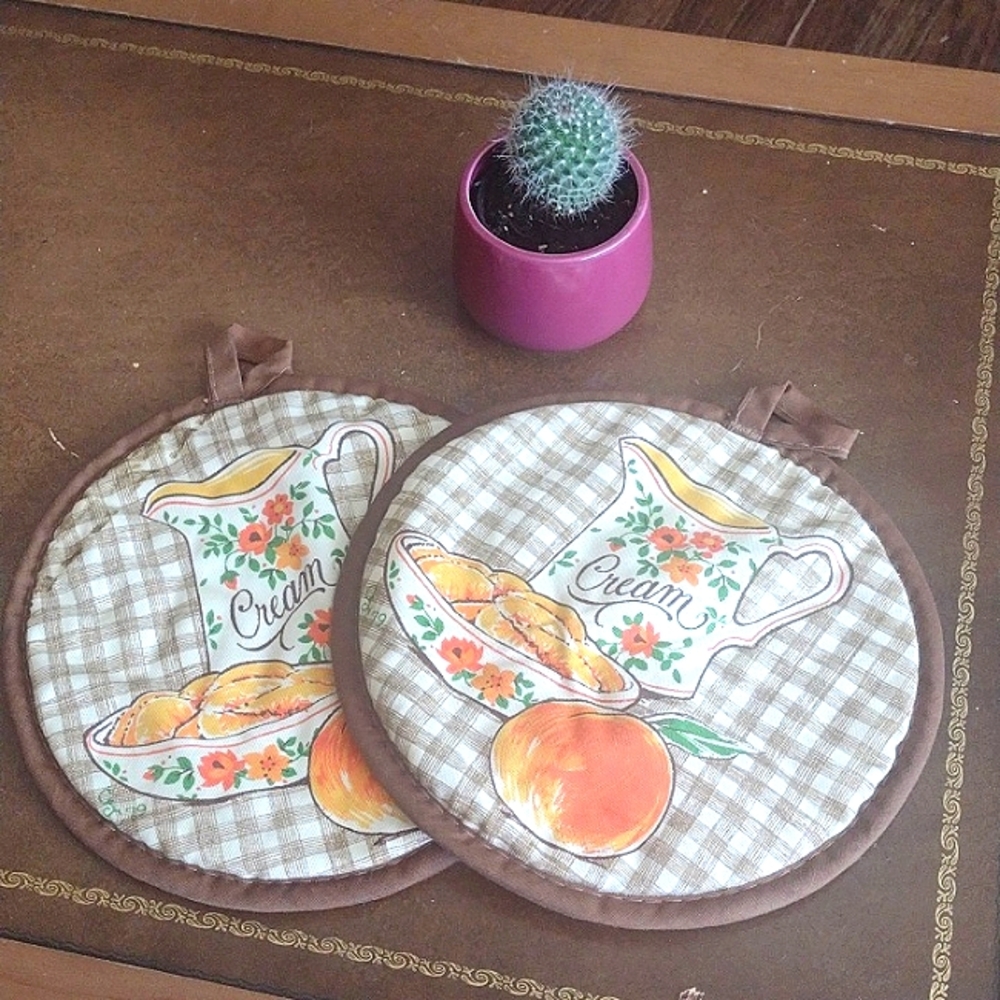 Vintage potholders. Brown, orange, cream pitcher and bowl with floral design.